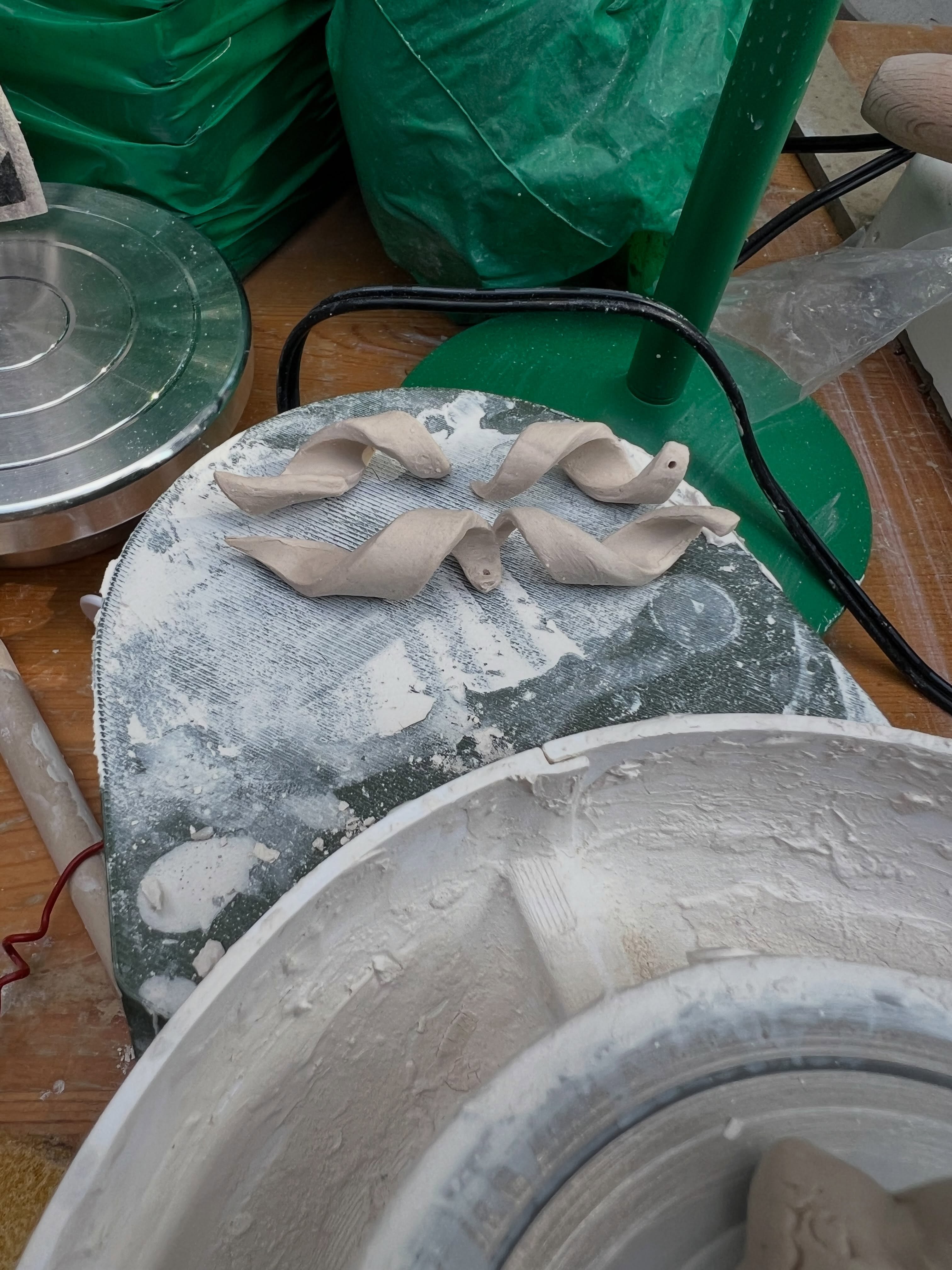 Freshly thrown clay pieces on the pottery wheel
